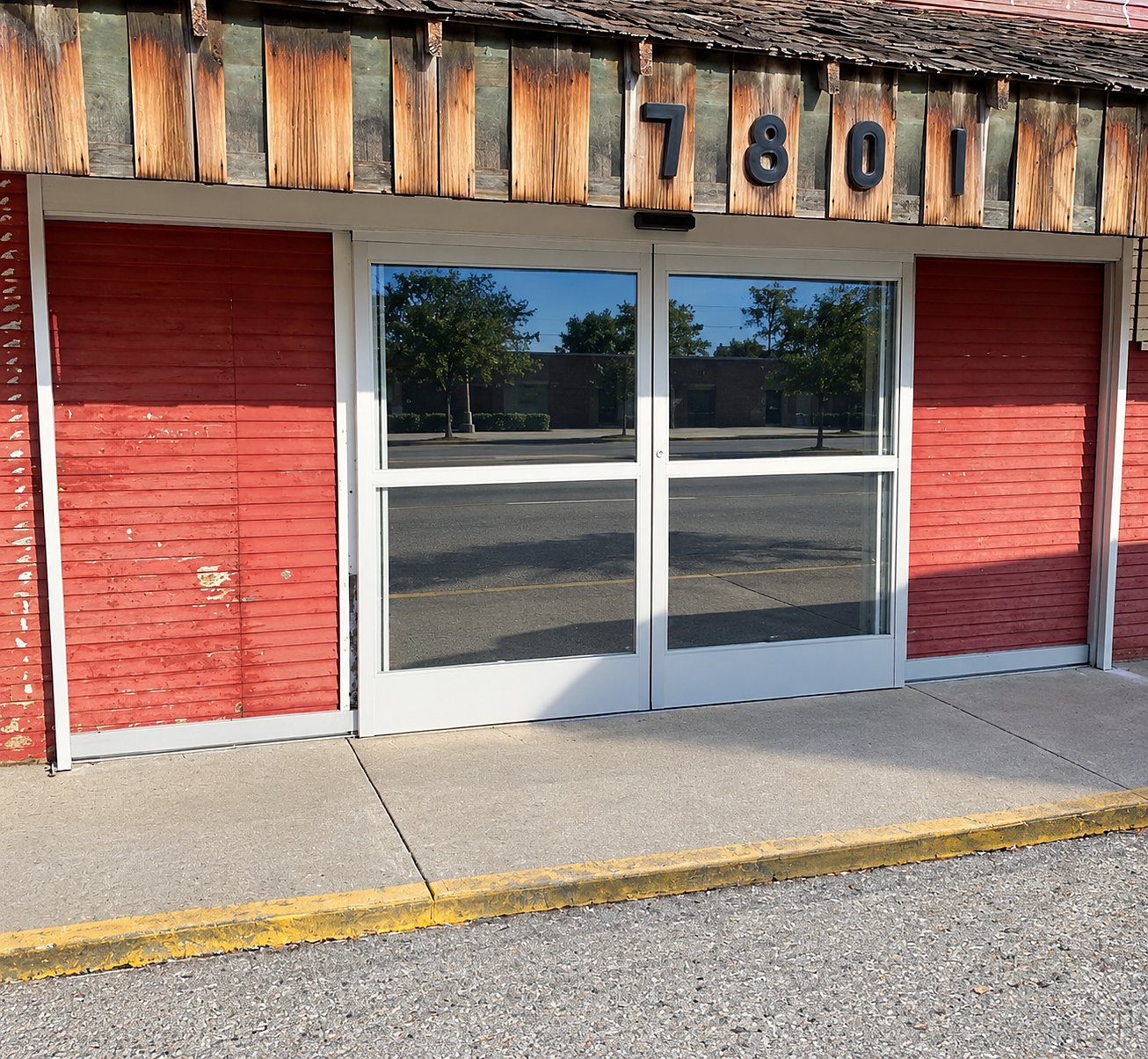 After: the same storefront with new bi-parting automatic sliding glass doors