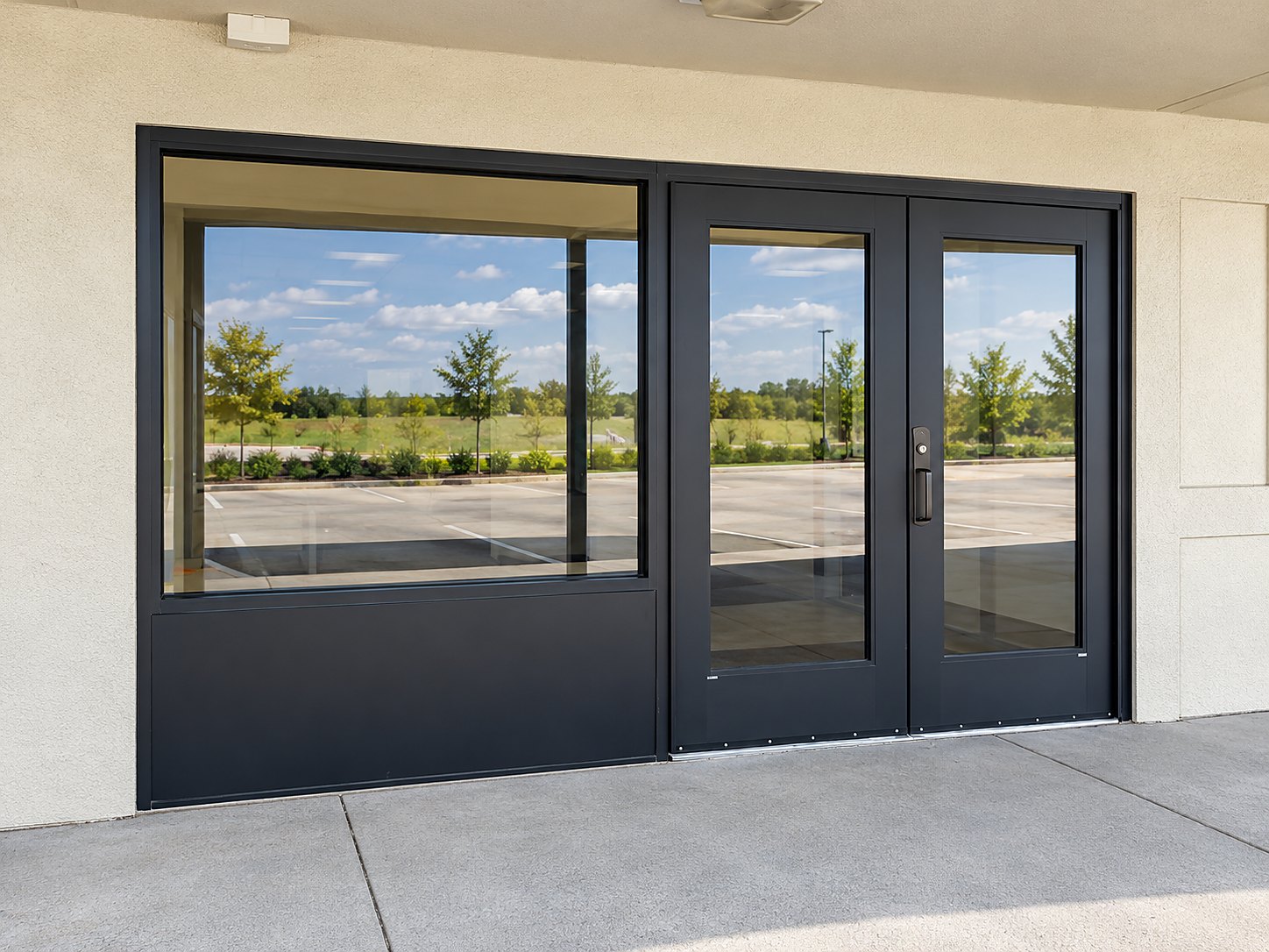 After: a new black aluminum storefront entrance with full-glass double doors